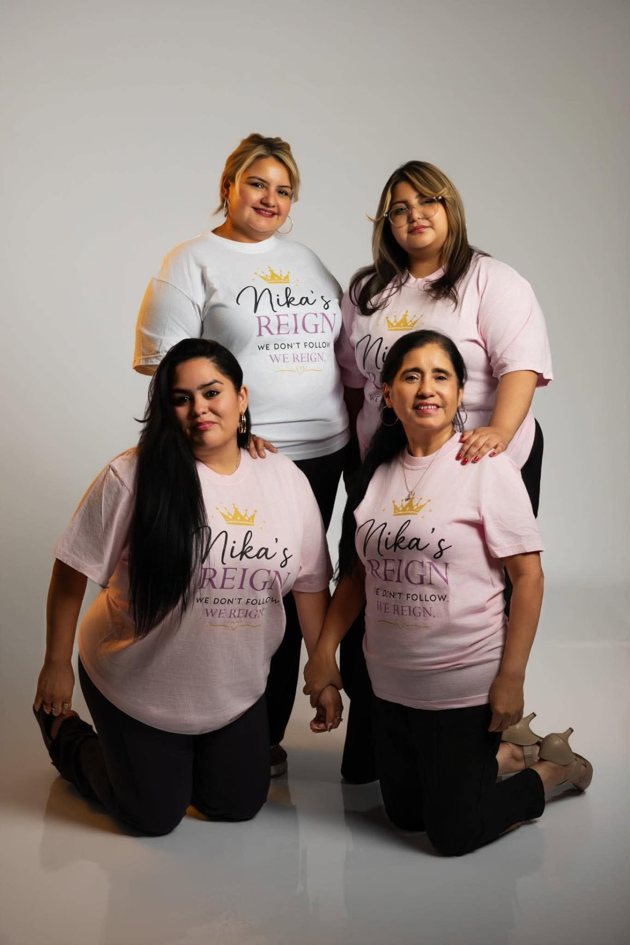 A wide group of women of many ages and backgrounds standing together